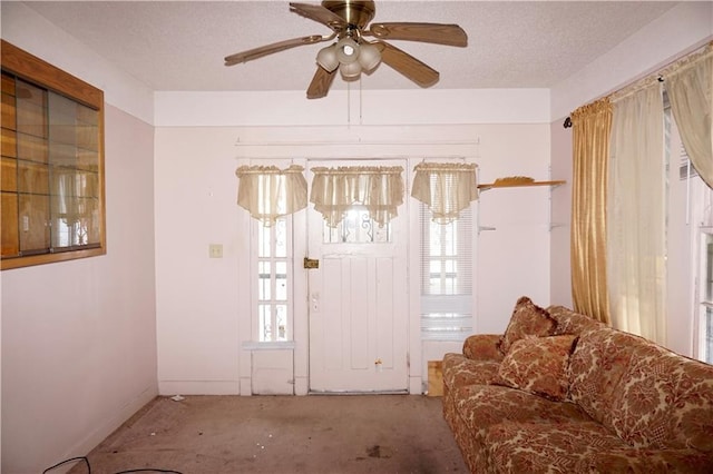 382426 Royal St, New Orleans, LA 70117 - entrance foyer featuring carpet, plenty of natural light, a textured ceiling, ceiling fan, and baseboards