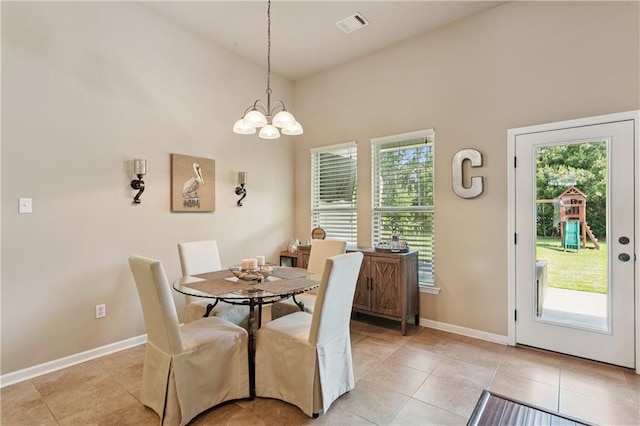 724 Fairfield Loop, Slidell, LA 70458 - dining room featuring healthy amount of natural light, a chandelier, light tile patterned floors, and a high ceiling