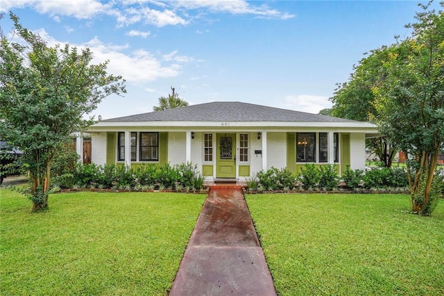 601 Andrews Ave, Metairie, LA 70005 - view of front of home with covered porch, a front yard, and brick siding