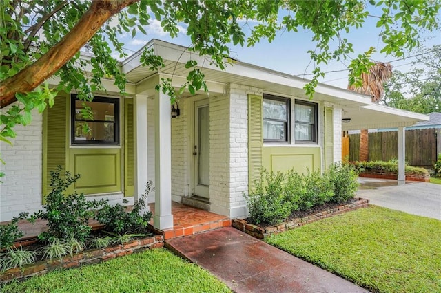 601 Andrews Ave, Metairie, LA 70005 - view of front of home featuring brick siding, an attached carport, driveway, and covered porch