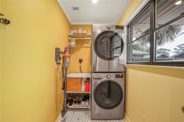 601 Andrews Ave, Metairie, LA 70005 - washroom with estacked washer and dryer, ornamental molding, baseboards, and tile patterned flooring