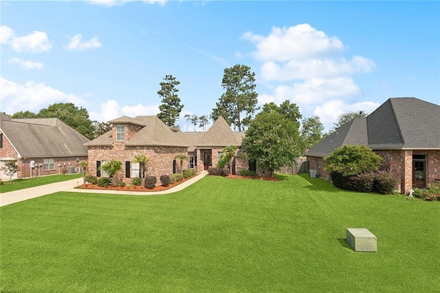 1037 Scarlet Oak Ln, Mandeville, LA 70448 - view of front of home with brick siding, a front yard, and driveway