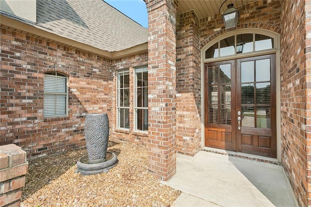1037 Scarlet Oak Ln, Mandeville, LA 70448 - doorway to property with french doors, brick siding, and a shingled roof