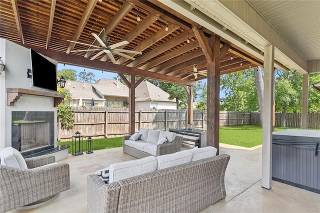 1037 Scarlet Oak Ln, Mandeville, LA 70448 - view of patio / terrace with a ceiling fan, a hot tub, and an outdoor living space with a fireplace