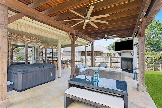 1037 Scarlet Oak Ln, Mandeville, LA 70448 - view of patio / terrace with a ceiling fan, a hot tub, and an outdoor living space with a fireplace