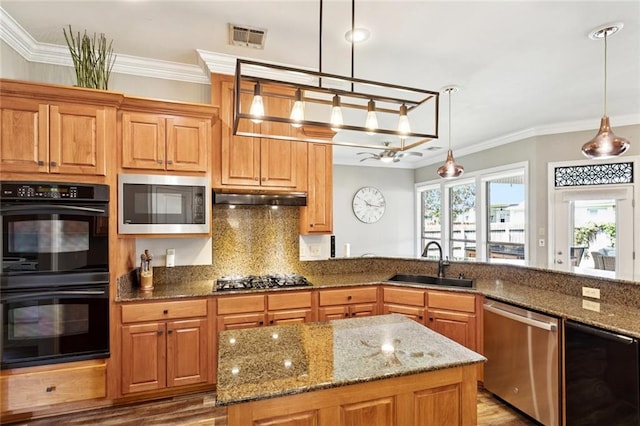 1037 Scarlet Oak Ln, Mandeville, LA 70448 - kitchen featuring stainless steel appliances, a sink, under cabinet range hood, crown molding, and light stone counters