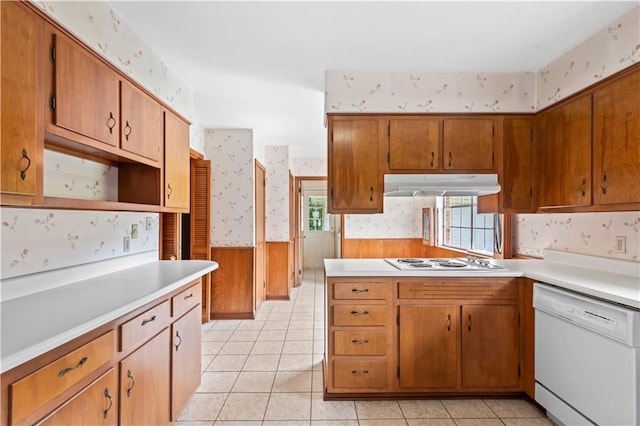 213 N Jayson Dr, Slidell, LA 70458 - kitchen with white appliances, wallpapered walls, under cabinet range hood, light countertops, and wainscoting