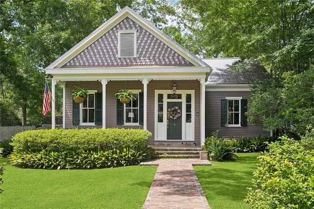 505 W 14th Ave, Covington, LA 70433 - victorian home featuring a front yard and covered porch