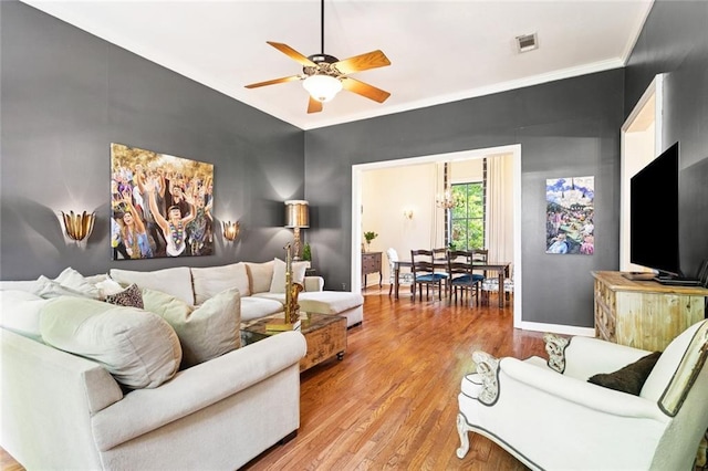 505 W 14th Ave, Covington, LA 70433 - living room featuring wood finished floors, ceiling fan, crown molding, and baseboards