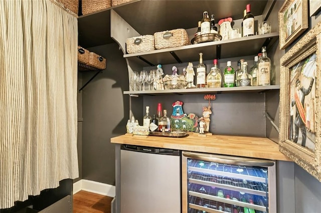 505 W 14th Ave, Covington, LA 70433 - indoor dry bar with beverage cooler, refrigerator, wood finished floors, and baseboards