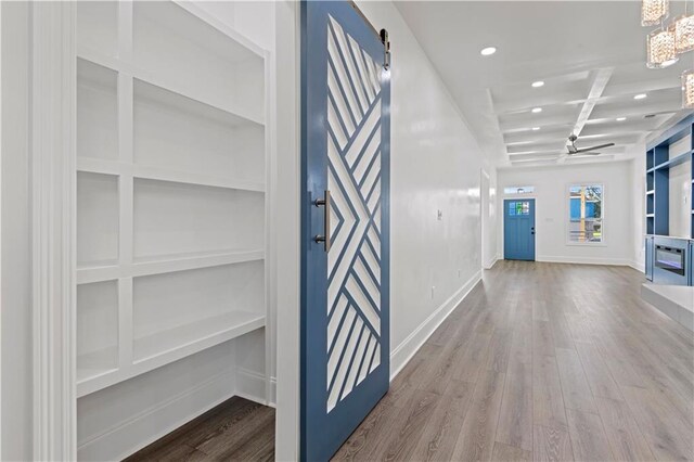 3414 Monroe St, New Orleans, LA 70118 - hallway featuring a chandelier, wood finished floors, built in features, recessed lighting, and baseboards
