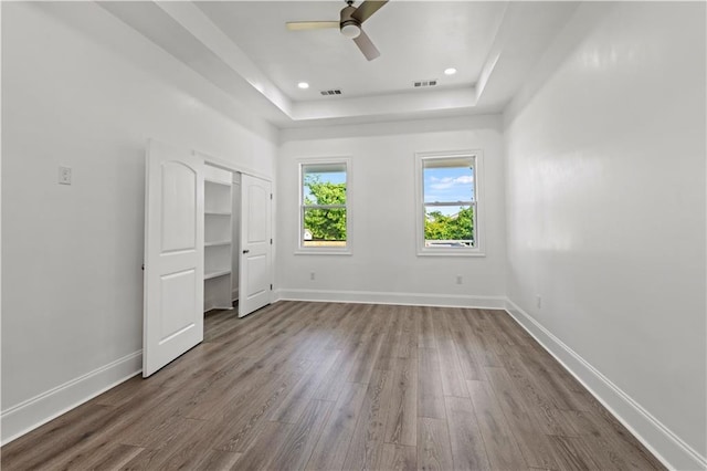 3414 Monroe St, New Orleans, LA 70118 - unfurnished bedroom featuring a raised ceiling, wood finished floors, baseboards, and ceiling fan