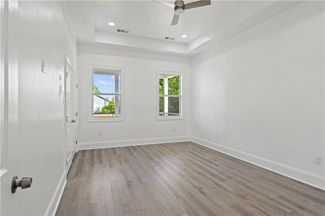 3414 Monroe St, New Orleans, LA 70118 - empty room featuring wood finished floors, a raised ceiling, baseboards, a ceiling fan, and recessed lighting