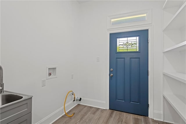3414 Monroe St, New Orleans, LA 70118 - washroom featuring a sink, hookup for a washing machine, wood finished floors, and baseboards