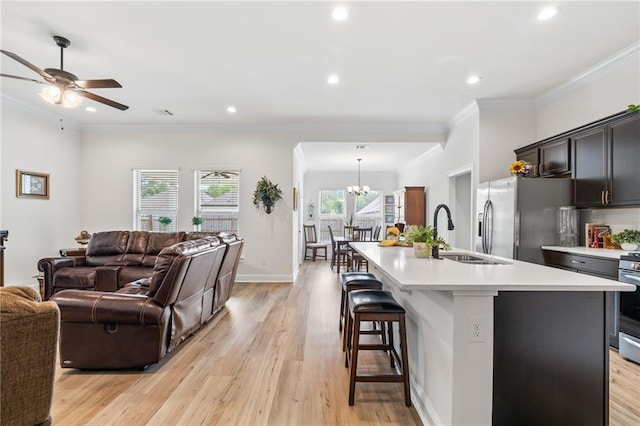 22039 Giselle Dr, Mandeville, LA 70471 - living area with a chandelier, light wood-style flooring, ornamental molding, recessed lighting, and ceiling fan