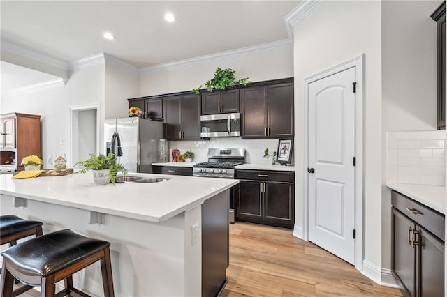 22039 Giselle Dr, Mandeville, LA 70471 - kitchen with stainless steel appliances, crown molding, a breakfast bar, backsplash, and a center island with sink