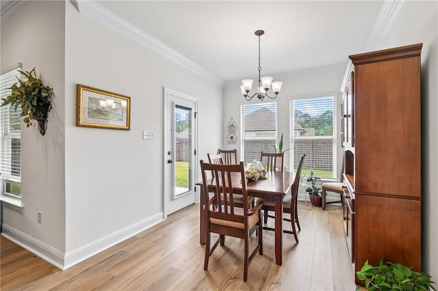 22039 Giselle Dr, Mandeville, LA 70471 - dining room featuring light wood finished floors, ornamental molding, a chandelier, and baseboards