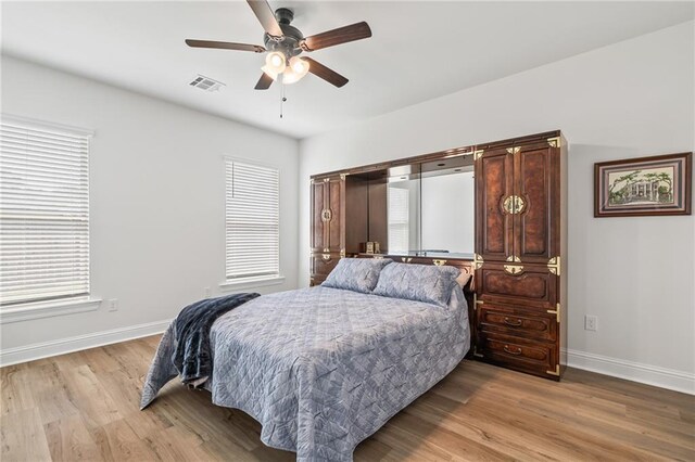 22039 Giselle Dr, Mandeville, LA 70471 - bedroom with baseboards, light wood-style flooring, and ceiling fan