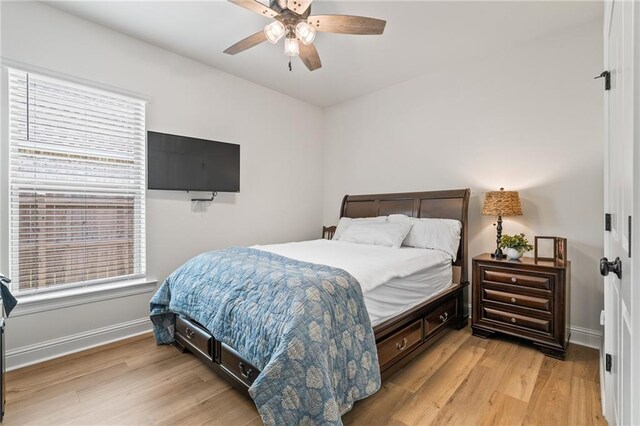 22039 Giselle Dr, Mandeville, LA 70471 - bedroom with light wood-style flooring, baseboards, and a ceiling fan