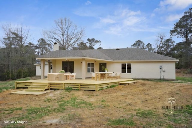 21507 Birtrue Rd, Bush, LA 70431 - back of property with a chimney, a wooden deck, and stucco siding
