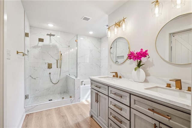21507 Birtrue Rd, Bush, LA 70431 - full bath featuring double vanity, a marble finish shower, a garden tub, wood finished floors, and recessed lighting