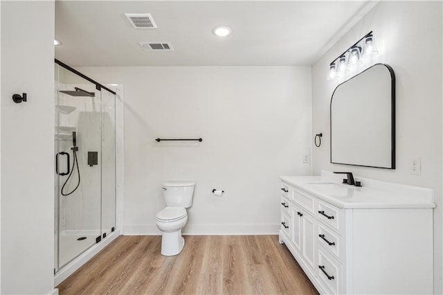 21507 Birtrue Rd, Bush, LA 70431 - bathroom with vanity, toilet, a shower stall, wood finished floors, and baseboards