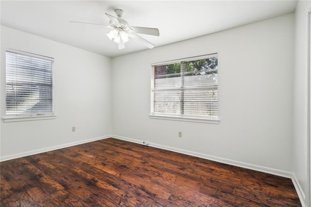 106 Walnut St, Mandeville, LA 70471 - spare room with baseboards, dark wood-style floors, and a ceiling fan