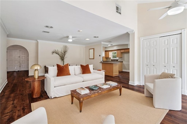 15 Forstall Ave, Kenner, LA 70065 - living area with a ceiling fan, ornamental molding, dark wood finished floors, arched walkways, and baseboards
