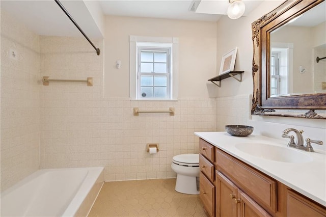 15 Forstall Ave, Kenner, LA 70065 - bathroom featuring vanity, toilet, shower / bath combination, tile walls, and wainscoting