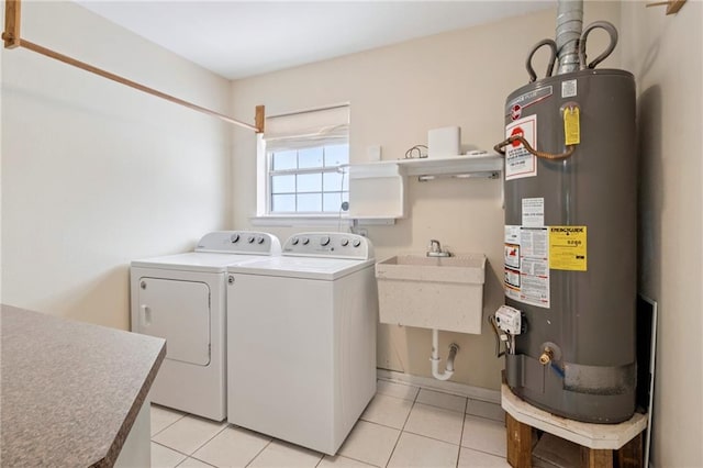 15 Forstall Ave, Kenner, LA 70065 - laundry area with gas water heater, washer and dryer, and light tile patterned flooring