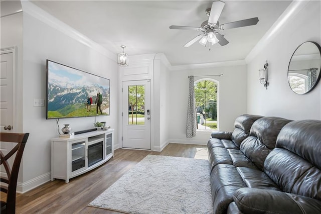 1951 Beth Dr, Slidell, LA 70458 - living room with wood finished floors, a ceiling fan, baseboards, and crown molding
