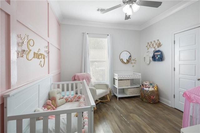 1951 Beth Dr, Slidell, LA 70458 - bedroom with wood finished floors, a nursery area, ornamental molding, and a ceiling fan