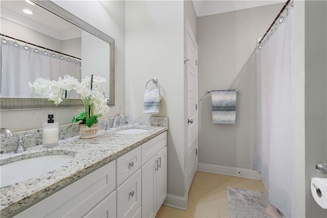 1951 Beth Dr, Slidell, LA 70458 - bathroom with double vanity, baseboards, and a shower with shower curtain