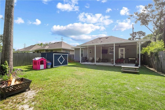 1951 Beth Dr, Slidell, LA 70458 - back of property featuring a fire pit, a ceiling fan, a patio area, and roof with shingles
