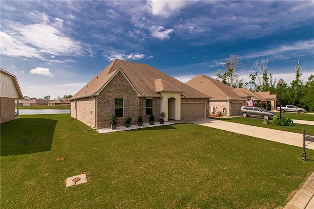 40262 Sedgwick Ln, Ponchatoula, LA 70454 - view of front of home with driveway, a garage, a front yard, and brick siding