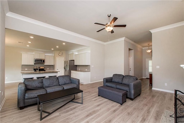 40262 Sedgwick Ln, Ponchatoula, LA 70454 - living room featuring light wood-type flooring, a ceiling fan, recessed lighting, and crown molding