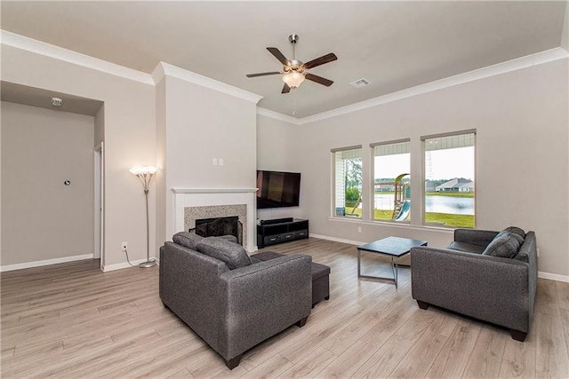 40262 Sedgwick Ln, Ponchatoula, LA 70454 - living room with ceiling fan, light wood-type flooring, crown molding, and a fireplace