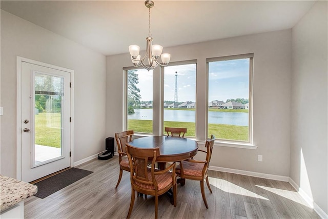 40262 Sedgwick Ln, Ponchatoula, LA 70454 - dining room featuring plenty of natural light, a chandelier, light wood-style flooring, and a water view