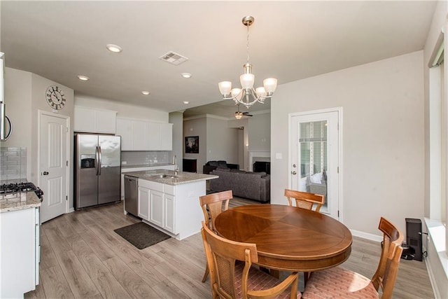 40262 Sedgwick Ln, Ponchatoula, LA 70454 - dining room featuring a chandelier, light wood-style floors, and recessed lighting