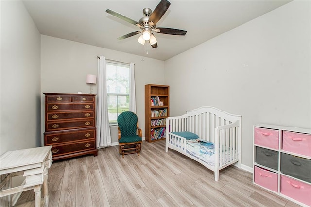 40262 Sedgwick Ln, Ponchatoula, LA 70454 - bedroom with wood finished floors, ceiling fan, and a nursery area