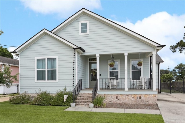 1908 Alexander Ave, Arabi, LA 70032 - view of front of home featuring a porch and a front lawn