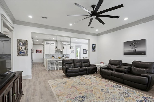 1908 Alexander Ave, Arabi, LA 70032 - living room with ornamental molding, a ceiling fan, light wood-style flooring, recessed lighting, and baseboards