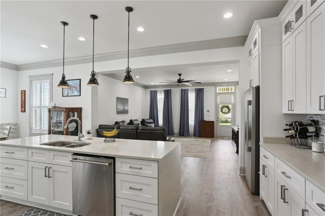 1908 Alexander Ave, Arabi, LA 70032 - kitchen featuring stainless steel appliances, a sink, ornamental molding, light countertops, and white cabinets