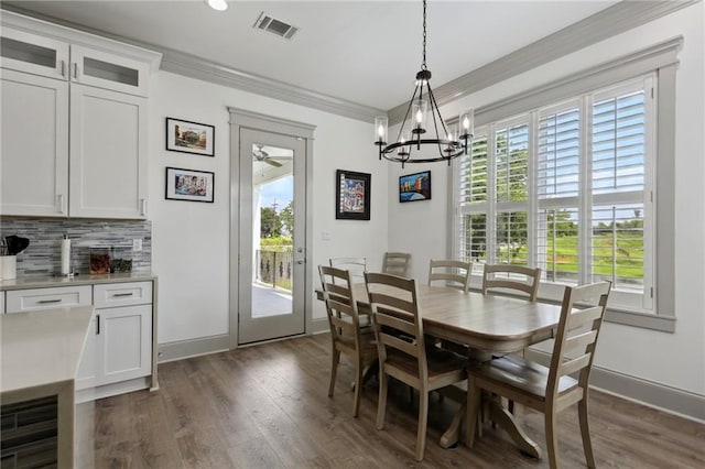 1908 Alexander Ave, Arabi, LA 70032 - dining space with a chandelier, ornamental molding, dark wood finished floors, baseboards, and ceiling fan