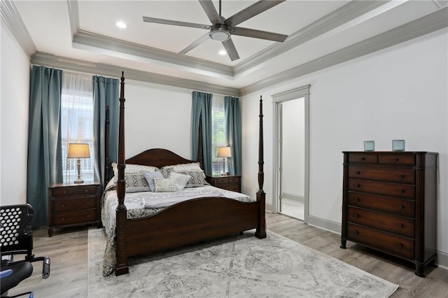 1908 Alexander Ave, Arabi, LA 70032 - bedroom featuring crown molding, a tray ceiling, light wood-style floors, ceiling fan, and baseboards