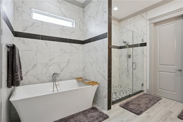 1908 Alexander Ave, Arabi, LA 70032 - full bathroom featuring a soaking tub, a marble finish shower, and wood finished floors