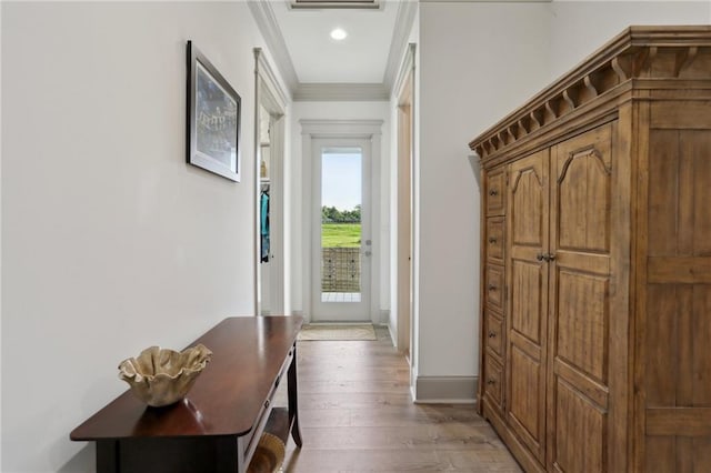 1908 Alexander Ave, Arabi, LA 70032 - doorway featuring crown molding, wood-type flooring, and baseboards