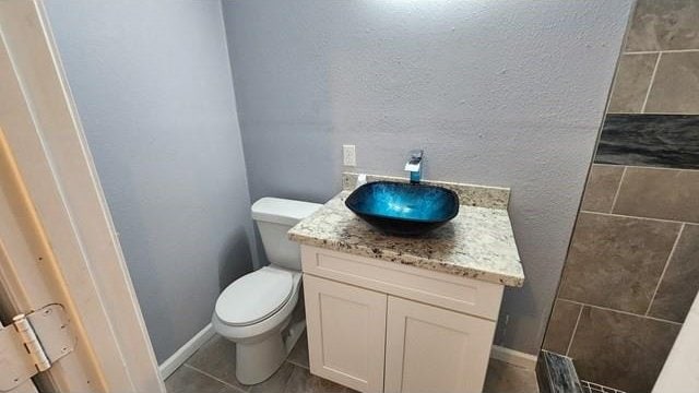 146 Elodie Ave, Harahan, LA 70123 - bathroom with toilet, vanity, tile patterned floors, and a textured wall