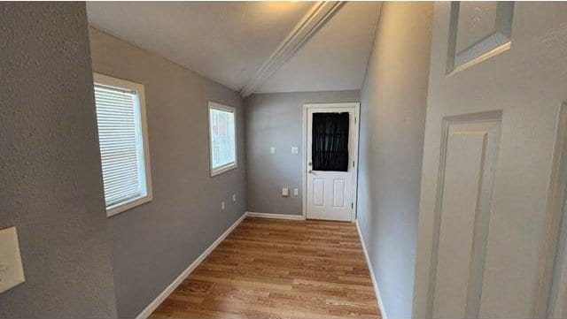 146 Elodie Ave, Harahan, LA 70123 - corridor with lofted ceiling, wood finished floors, and baseboards