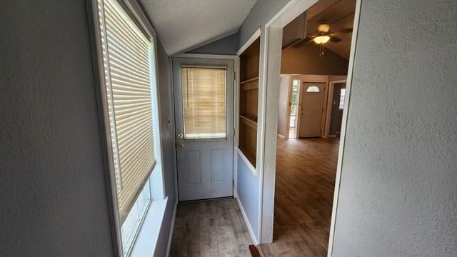 146 Elodie Ave, Harahan, LA 70123 - corridor with a textured wall, lofted ceiling, wood finished floors, built in features, and plenty of natural light